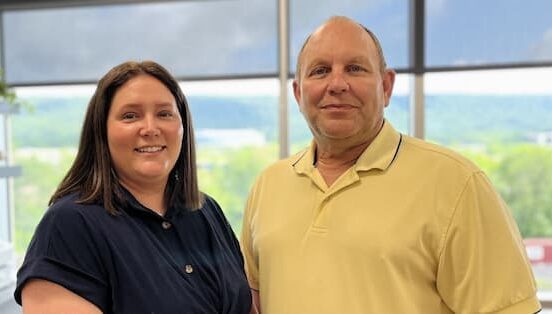 Stephen Janosko, PE, and Lauren Meadway, PE, CBSI, newly appointed leaders of Dawood’s Western Pennsylvania transportation team, standing together in a bright office with a scenic window view in the background.